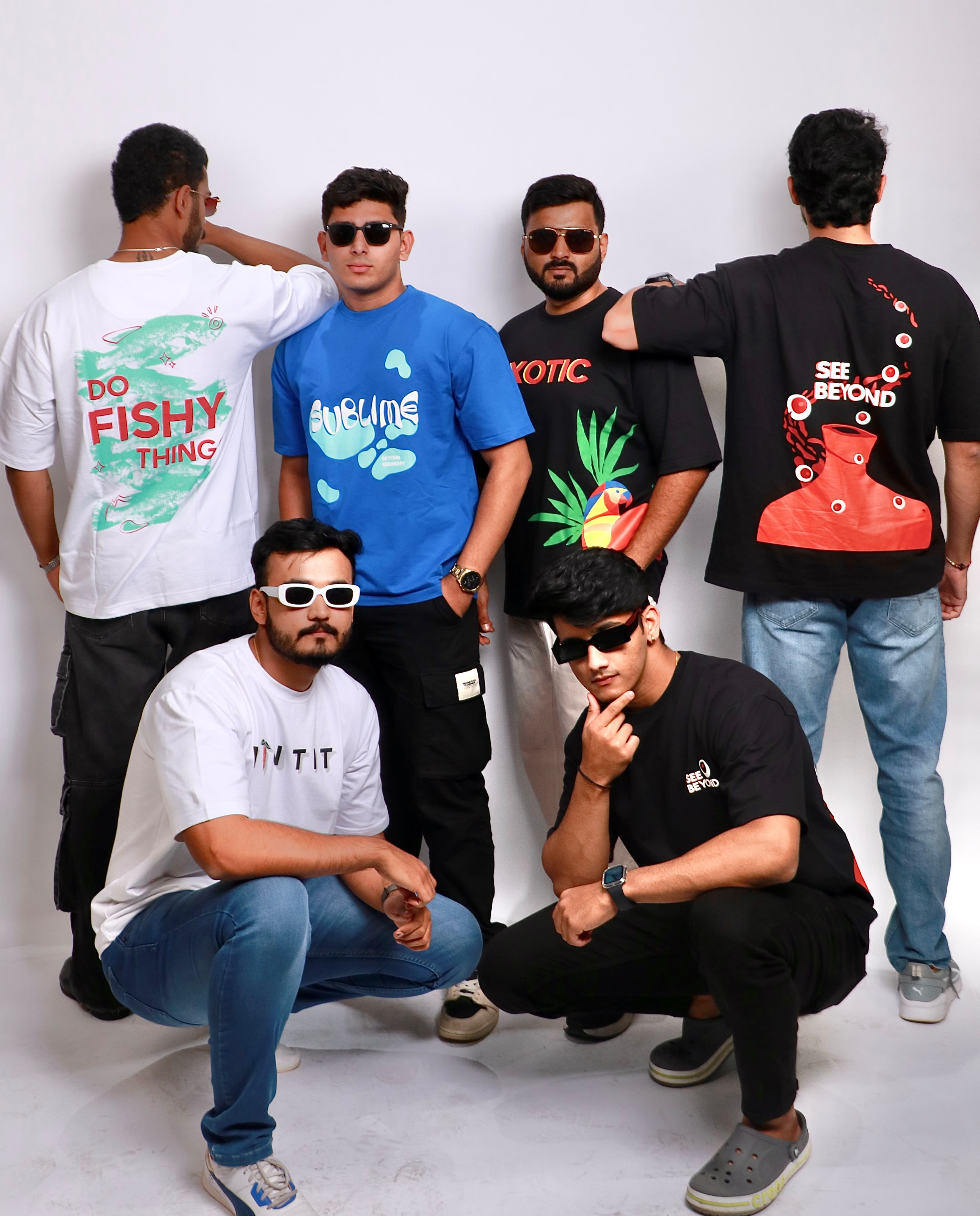 Modern unisex streetwear collection by Vintiti, featuring oversized t-shirts in bold and creative designs, modeled by six individuals.