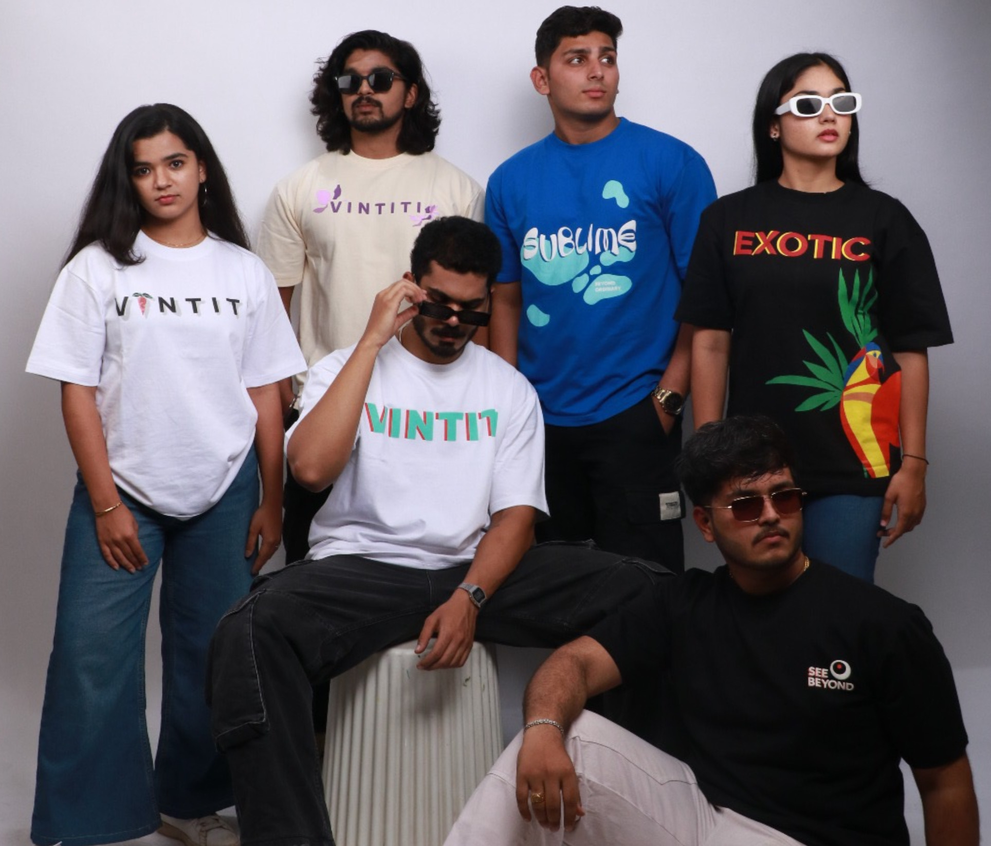 Group of models wearing Vintiti unisex oversized t-shirts, featuring vibrant designs and casual streetwear styles, showcasing the brand's diverse and inclusive fashion appeal.